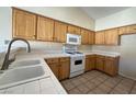 Functional kitchen with white appliances and tile countertops at 4941 Black Bear Rd # 202, Las Vegas, NV 89149