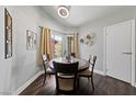 A cozy dining area with natural light, wood floors, and modern decor at 504 Crony Ave, Henderson, NV 89011