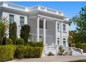 Elegant two-story home featuring grand columns, dual staircases, and manicured landscaping at 56 Quail Run Rd, Henderson, NV 89014