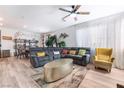 Open-concept living area with a large sectional sofa, stylish accents, and bright natural light throughout the room at 6141 May River St, Las Vegas, NV 89148
