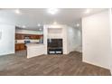 Open-concept living room with wood-style flooring seamlessly connected to the kitchen area at 6623 Hurkling Stone Ave, Las Vegas, NV 89139