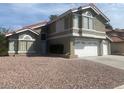 Inviting two-story home featuring a two-car garage and low-maintenance desert landscaping at 6736 Quinella Dr, Las Vegas, NV 89103