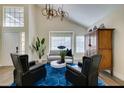 Bright living room with vaulted ceilings, stylish light fixture, and modern decor at 6736 Quinella Dr, Las Vegas, NV 89103