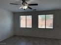 Living room with ceramic tile flooring, ceiling fan, and windows at 7246 Spring Flower Ave, Las Vegas, NV 89117