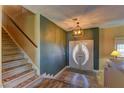 Warm entryway featuring unique double doors and a staircase with carpeted treads at 893 Fairway Dr, Boulder City, NV 89005