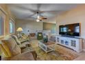 Cozy living room with comfortable seating, a decorative brick wall, and large windows at 893 Fairway Dr, Boulder City, NV 89005