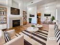 Bright living room featuring a fireplace, with views into the dining area and kitchen at 8985 S Durango Dr # 2081, Las Vegas, NV 89113