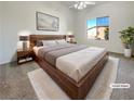 Well lit main bedroom features a ceiling fan and a large window at 8985 S Durango Dr # 2081, Las Vegas, NV 89113