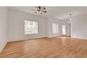 Spacious living room with wood floors, large windows, and ceiling fan at 9303 Gilcrease Ave # 1245, Las Vegas, NV 89149
