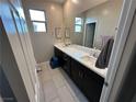 Bathroom with double vanity, sleek countertops, and modern fixtures providing a clean aesthetic at 10142 Skye Saddle Ave, Las Vegas, NV 89166