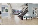 Open foyer featuring tile floors, staircase, and tasteful decor, creating a welcoming entrance at 10392 Smokemont Ct, Las Vegas, NV 89129