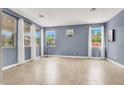 Bright living room filled with natural light, tile flooring, and neutral tones at 10392 Smokemont Ct, Las Vegas, NV 89129