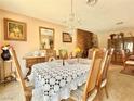 Elegant dining room featuring a chandelier, vintage decor, and a brick fireplace at 107 Elm St, Henderson, NV 89015