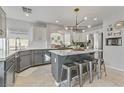 Modern kitchen featuring stainless steel appliances, marble countertops, and a stylish island with seating at 11009 Pentland Downs St, Las Vegas, NV 89141