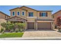 Well-maintained home featuring a brick driveway, stone accents, and a two-car garage at 12296 Kings Eagle St, Las Vegas, NV 89141