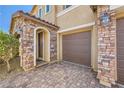 Charming house featuring stone accents on the garage and porch, and a brick driveway at 12296 Kings Eagle St, Las Vegas, NV 89141