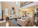 Bright, staged living room boasts soaring ceilings, natural light, and elegant decor at 12296 Kings Eagle St, Las Vegas, NV 89141