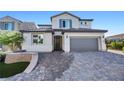 Charming two-story home with a brick driveway and manicured lawn offering a welcoming curb appeal at 12705 Coastline Shadow St, Las Vegas, NV 89141