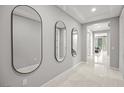 Bright foyer with stylish mirrors, tile flooring, and an inviting open floor plan at 12705 Coastline Shadow St, Las Vegas, NV 89141