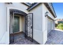 Ornate security door and a gray front door that enhances the home's curb appeal at 12705 Coastline Shadow St, Las Vegas, NV 89141