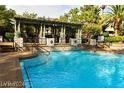 Resort-style pool with a covered patio lounge area and ample seating at 1605 Crimson Hills Dr # 204, Las Vegas, NV 89128