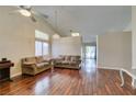 Spacious living room with hardwood floors, vaulted ceilings, neutral paint and a ceiling fan at 1824 Dawn Ridge Ave, Henderson, NV 89074