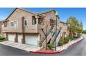 Inviting townhouse complex with attached garages and well-maintained landscaping at 2052 Gravel Hill St # 207, Las Vegas, NV 89117