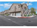 Inviting townhouse complex with attached garages and well-maintained landscaping at 2052 Gravel Hill St # 207, Las Vegas, NV 89117