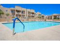 Sparkling community pool with ample lounge seating and desert landscaping at 2240 Highpointe Dr # 203, Laughlin, NV 89029