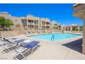 Sparkling community pool with ample lounge seating and desert landscaping at 2240 Highpointe Dr # 203, Laughlin, NV 89029