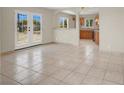 Sunlit living room featuring tile floors, French doors, and an open view to the kitchen at 2257 Colebrook St, Las Vegas, NV 89115