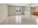 Living room featuring tile floors, French doors, and an open view to the kitchen at 2257 Colebrook St, Las Vegas, NV 89115