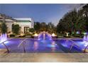 Backyard pool area with fountains, fire bowls, and manicured hedges at 2323 Pinto Ln, Las Vegas, NV 89107