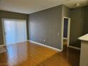 Open-concept living room boasts hardwood floors leading to the kitchen area at 2615 W Gary Ave # 1085, Las Vegas, NV 89123
