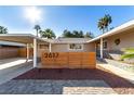 Inviting single-story home with carport, desert landscaping, and brick-paved driveway at 2617 Mason Ave, Las Vegas, NV 89102