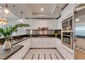 Modern kitchen features stainless steel appliances, white cabinetry, and stunning pendant lights at 2700 Las Vegas Blvd # 505, Las Vegas, NV 89109