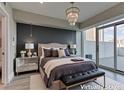 This bedroom offers a luxurious feel with a decorative light fixture, bench and terrace access at 2700 Las Vegas Blvd # 505, Las Vegas, NV 89109