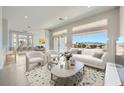 Bright living room with contemporary furnishings and expansive windows showcasing mountain views at 2904 Bow Bridge Dr, Las Vegas, NV 89134