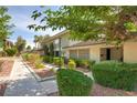 Well-maintained home featuring manicured landscaping, mature trees, and a charming exterior facade at 3062 El Camino Ave, Las Vegas, NV 89102
