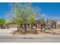 Inviting single-story home with stone accents, desert landscaping, and an attached two-car garage at 3910 Internet Ave, North Las Vegas, NV 89031