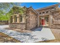 Close-up view of the stone facade and gated entrance of a beautiful single-story home at 3910 Internet Ave, North Las Vegas, NV 89031