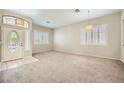 Spacious living room featuring plush carpeting, neutral walls, and ample natural light from shuttered windows at 417 Carlton Kay Pl, Las Vegas, NV 89144