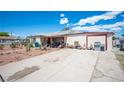 Single-story home with spacious driveway and low-maintenance desert landscaping at 4412 Baxter Pl, Las Vegas, NV 89107