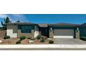 Inviting single-story home boasting desert-style landscaping and a convenient two-car garage, perfect for modern living at 4844 E Cactus Canyon Dr, Pahrump, NV 89061