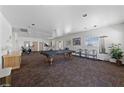 Bright common room with billiards, exercise equipment, and ample seating for residents enjoyment at 4940 Mascaro Dr, Las Vegas, NV 89122