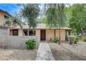 Charming single-story home featuring desert landscaping and a front entryway with a walkway at 5020 Village Dr, Las Vegas, NV 89142