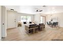 Inviting living room with large window providing natural light, neutral color palette, and open dining area at 5020 Village Dr, Las Vegas, NV 89142