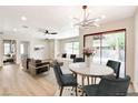 Open-concept living space featuring wood floors, modern furnishings, and a sliding glass door to the exterior at 5020 Village Dr, Las Vegas, NV 89142