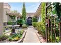 Private courtyard featuring a serene fountain, lush greenery, and brick pathway to the front door at 517 Spruce Canyon St, Las Vegas, NV 89144