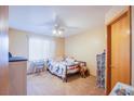 Cozy bedroom featuring a ceiling fan, plush carpet, and a sun-filled window for natural light at 5180 N Dapple Gray Rd, Las Vegas, NV 89149